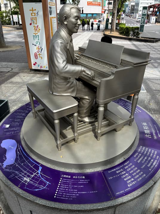 福島駅東口の駅前広場に置かれた、オルガンを演奏する古関裕而のモニュメント